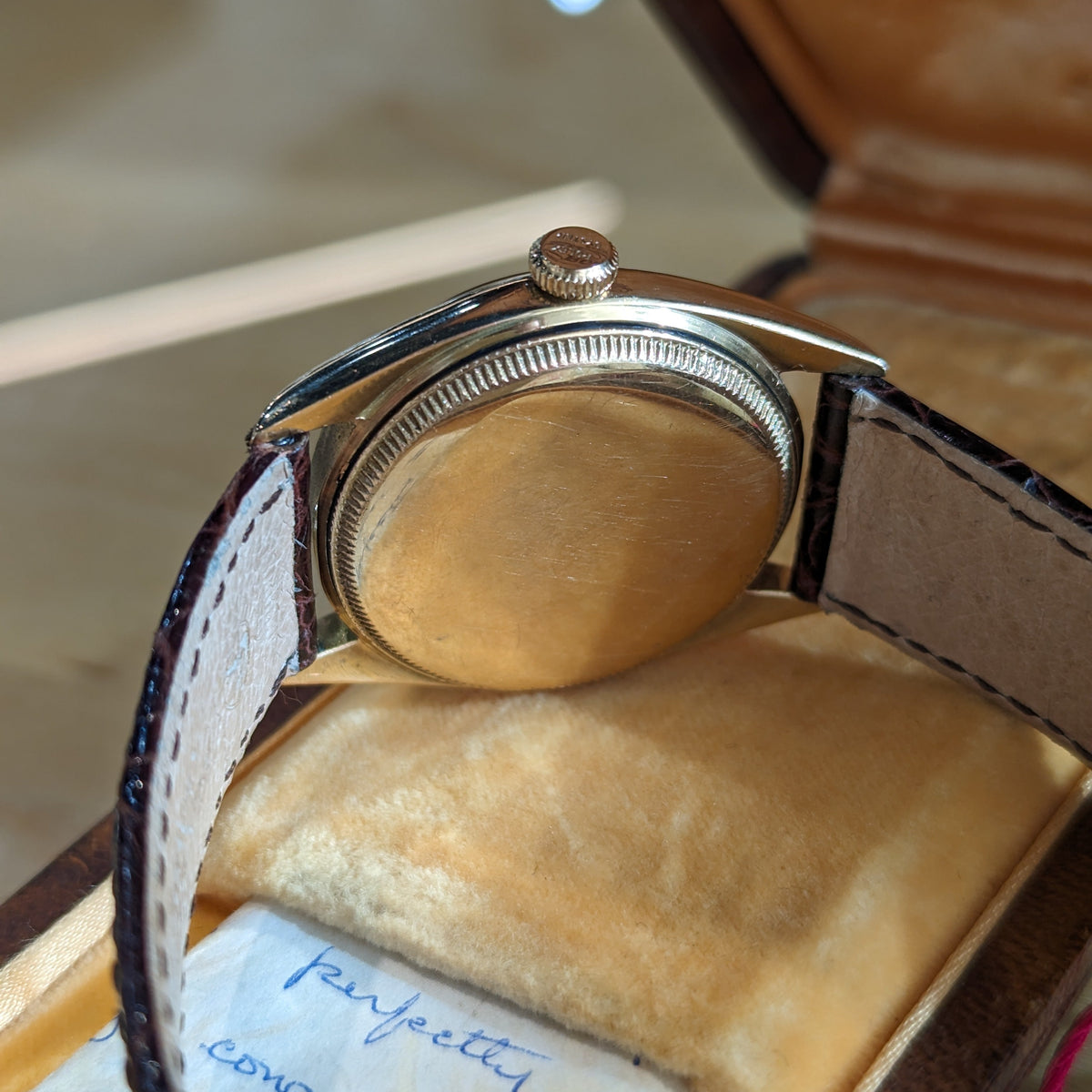 Side view of Rolex unisex gold watch