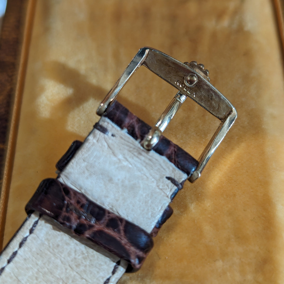 Angled view of Rolex unisex gold watch