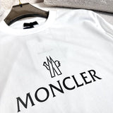 Close-up detail shot of Moncler luxury clothing with monogram-inspired silhouette