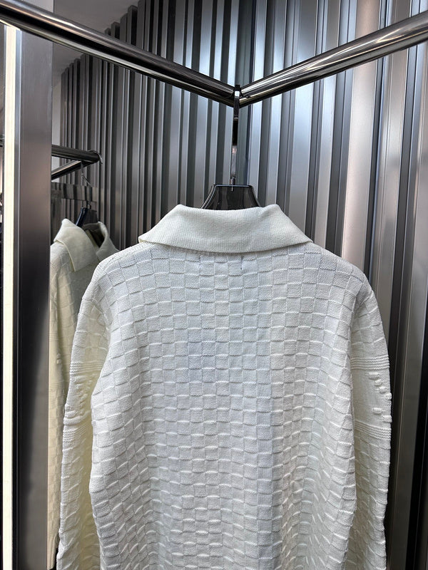 Flat lay presentation of Louis Vuitton luxury clothing with runway-inspired design