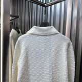 Flat lay presentation of Louis Vuitton luxury clothing with runway-inspired design