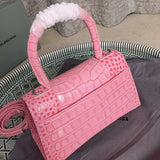 Handle and strap detail of statement polished women's handbag – women's statement bag