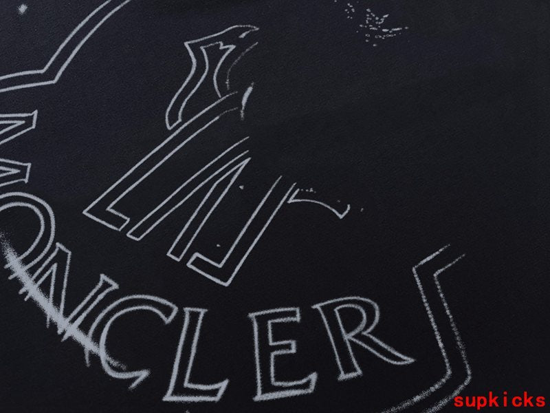 Flat lay presentation of Moncler luxury clothing with monogram-inspired silhouette