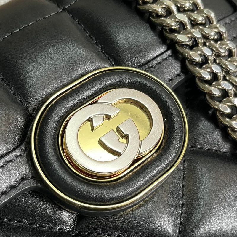 Styled lifestyle shot of signature polished women's handbag – women's luxury accessory