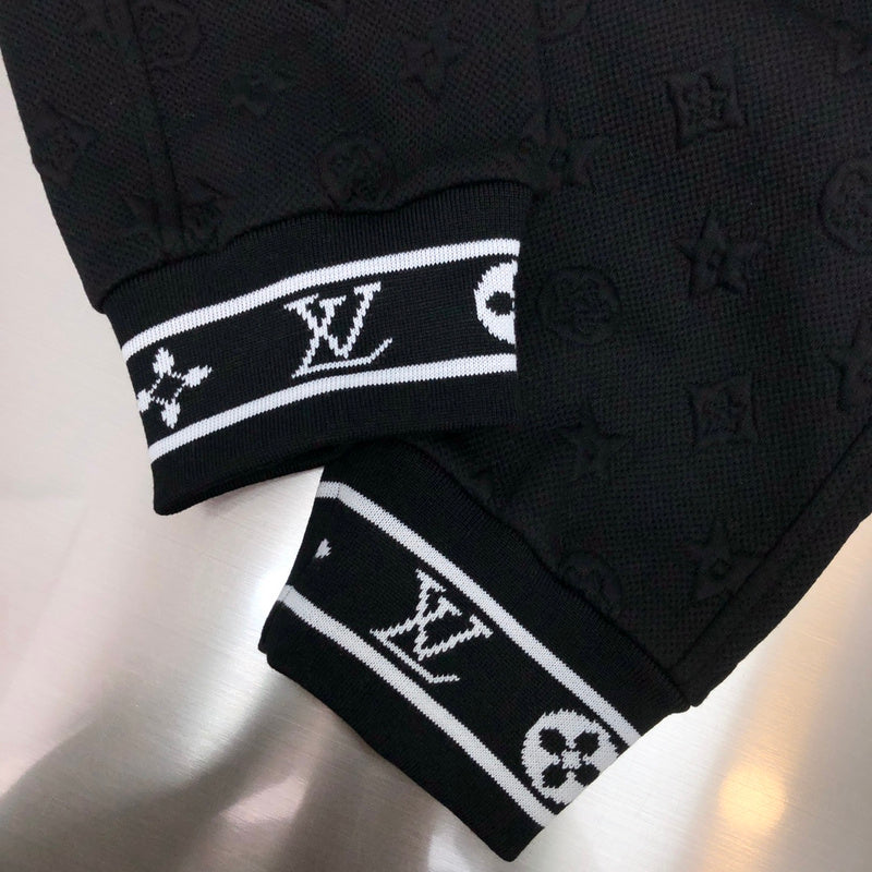 Flat lay presentation of Louis Vuitton luxury clothing with signature branding