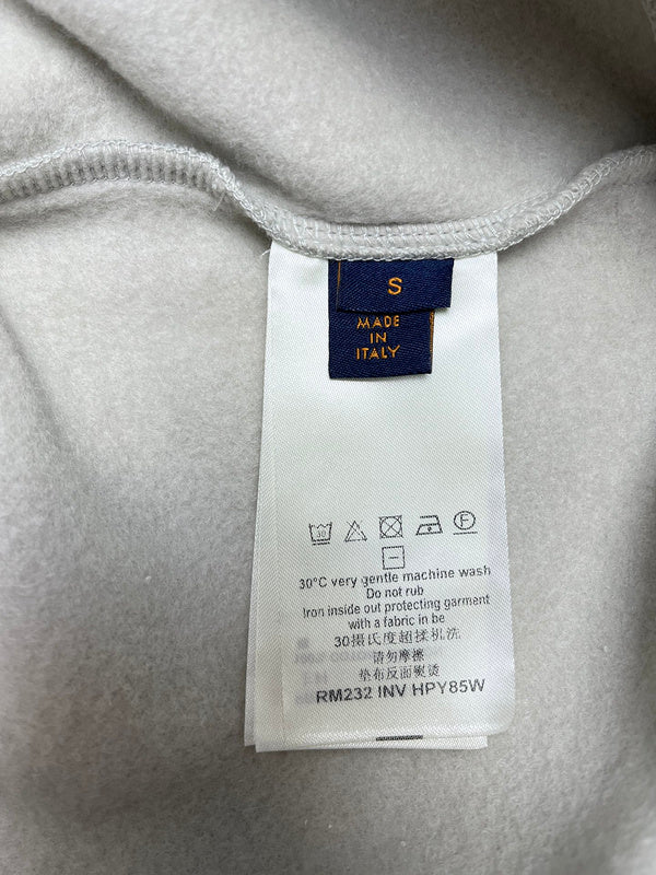 Close-up detail shot of Louis Vuitton luxury clothing with monogram-inspired silhouette