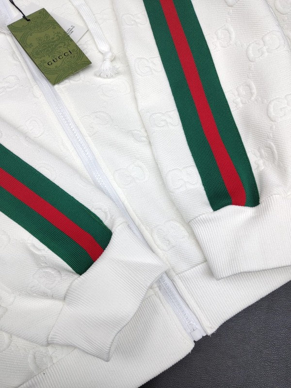 Flat lay presentation of Gucci luxury clothing with label-forward styling