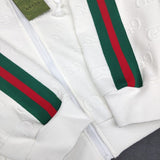 Flat lay presentation of Gucci luxury clothing with label-forward styling