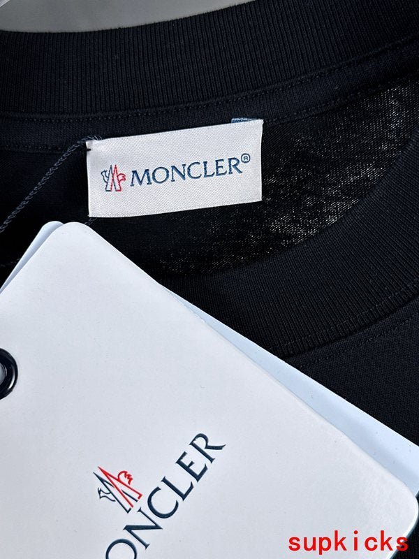 Flat lay presentation of Moncler luxury clothing with everyday silhouette