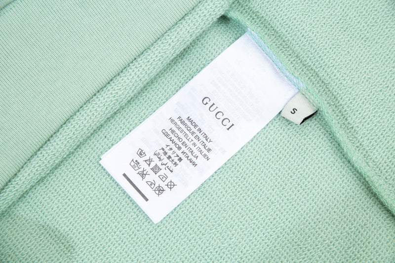 Close-up detail shot of Gucci luxury clothing with contemporary cut