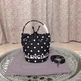 Side profile of polished elevated women's handbag – women's luxury accessory