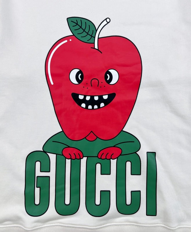 Flat lay presentation of Gucci luxury clothing with signature branding