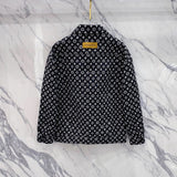 Close-up detail shot of Louis Vuitton luxury clothing with label-forward styling