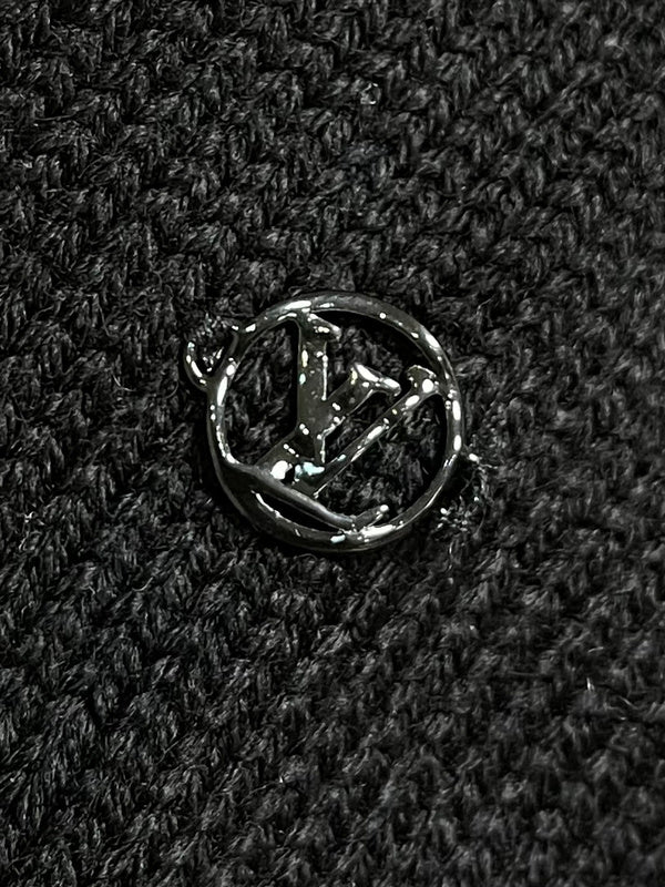 Flat lay presentation of Louis Vuitton luxury clothing with monogram-inspired silhouette