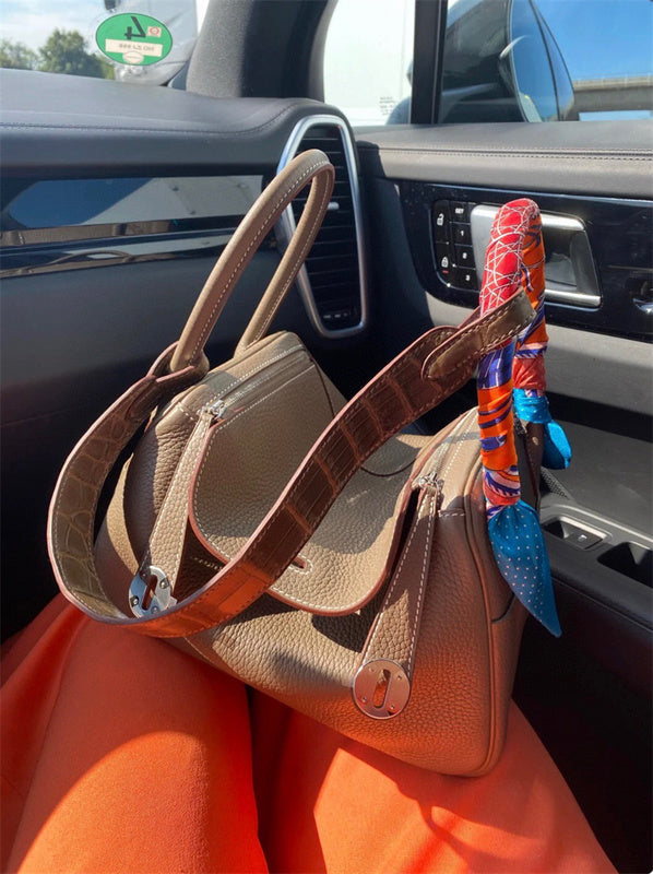  Elegant top-handle bag carried on shoulder