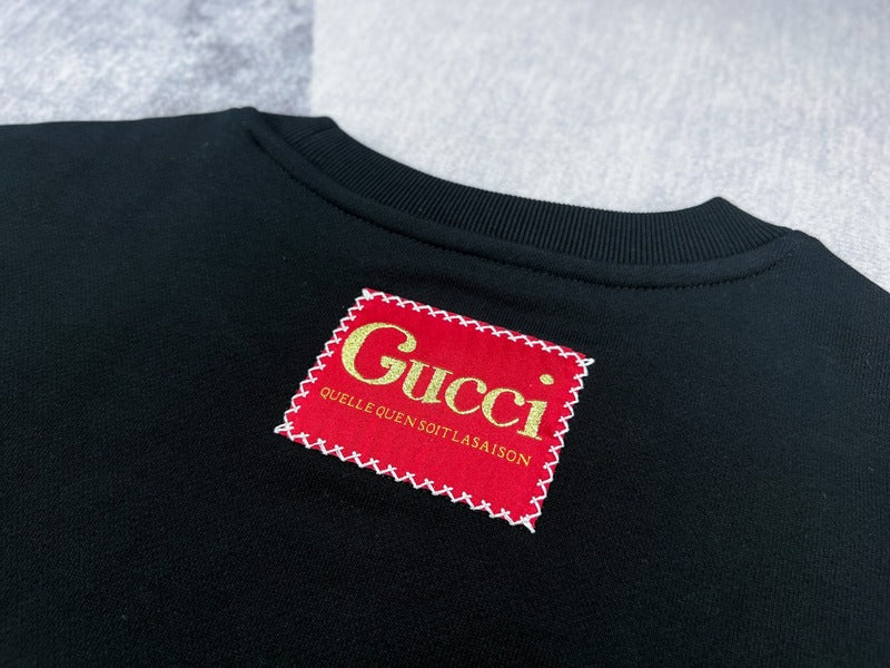 Front view of Gucci luxury clothing with signature branding