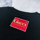 Front view of Gucci luxury clothing with signature branding
