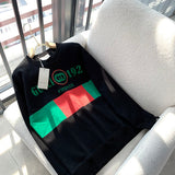 Flat lay presentation of Gucci luxury clothing with monogram-inspired silhouette
