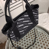 Styled lifestyle shot of chic polished women's handbag – women's luxury handbag
