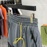 Front view of Rhude luxury clothing with monogram-inspired silhouette