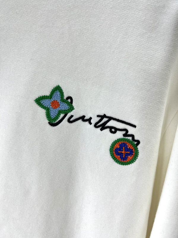 Flat lay presentation of Louis Vuitton luxury clothing with logo-detail design