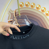 Flat lay presentation of Louis Vuitton luxury clothing with monogram-inspired silhouette