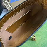 Side profile of elevated modern women's handbag – women's luxury accessory