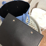 Side profile of structured polished women's handbag – women's statement bag