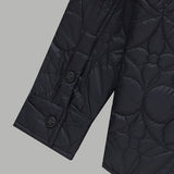 Close-up detail shot of Louis Vuitton luxury clothing with monogram-inspired silhouette