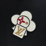 Flat lay presentation of Louis Vuitton luxury clothing with label-forward styling