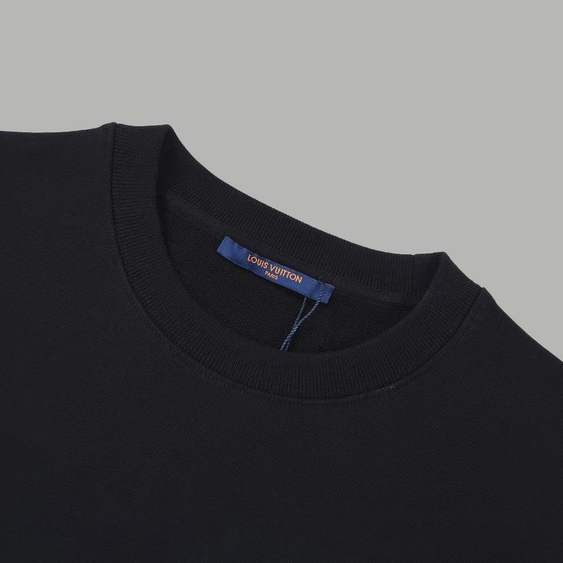 Flat lay presentation of Louis Vuitton luxury clothing with signature branding
