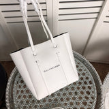 Front view of modern refined women's handbag – women's statement bag