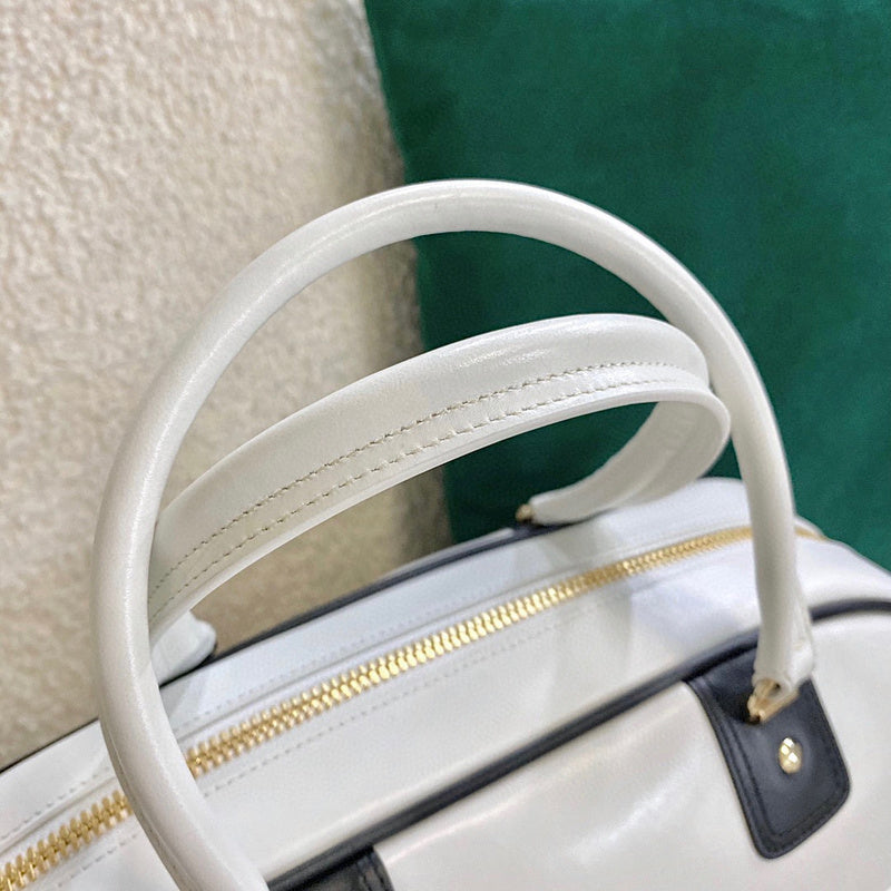 Handle and strap detail of modern polished women's handbag – women's luxury handbag