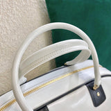 Handle and strap detail of modern polished women's handbag – women's luxury handbag