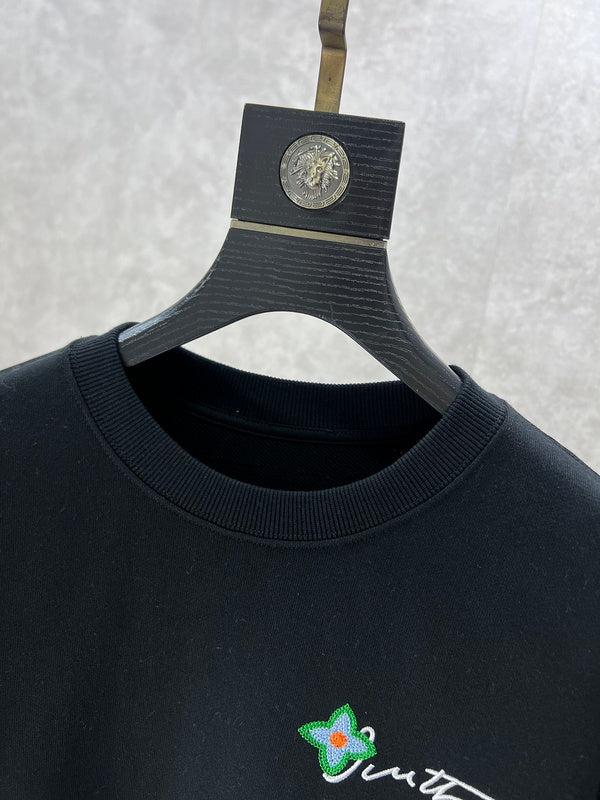 Close-up detail shot of Louis Vuitton luxury clothing with logo-detail design