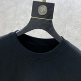 Close-up detail shot of Louis Vuitton luxury clothing with logo-detail design