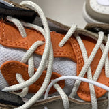 Side profile of Nike bold contrast sneakers signature lace-up style