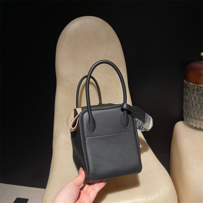 Side view of tailored structured handbag