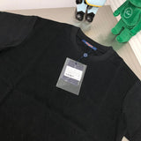 Close-up detail shot of Louis Vuitton cotton t-shirt with label-forward styling