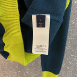 Close-up detail shot of Louis Vuitton luxury clothing with label-forward styling