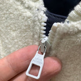 Flat lay presentation of Louis Vuitton luxury clothing with label-forward styling
