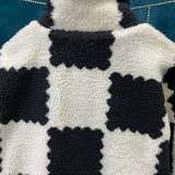 Back view of Louis Vuitton luxury clothing with signature branding