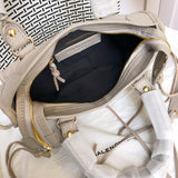Side profile of polished classic women's handbag – women's luxury accessory