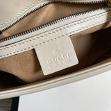 Side profile of signature polished women's handbag – women's designer-style accessory