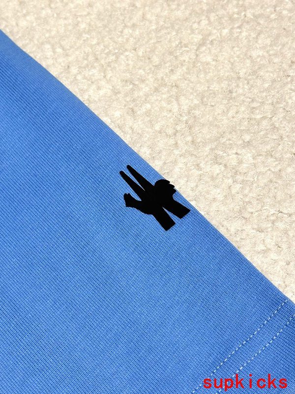Flat lay presentation of Moncler luxury clothing with signature branding