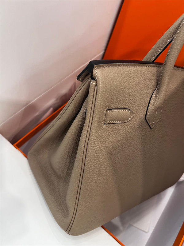  sleek top-handle bag styled with outfit