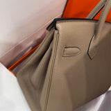  sleek top-handle bag styled with outfit
