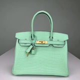Side view of streamlined structured handbag
