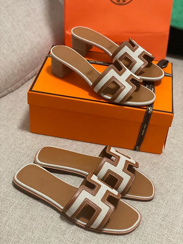 Hermes sandals Style 002 - close-up of iconic logo design