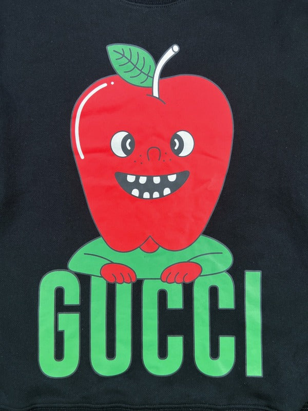 Flat lay presentation of Gucci luxury clothing with signature branding